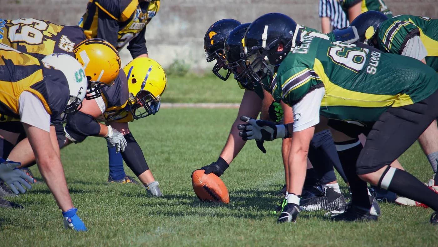 A high-school football game at the line of scrimmage