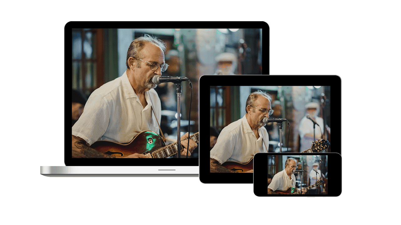 A video of a person playing guitar plays on three different streaming devices