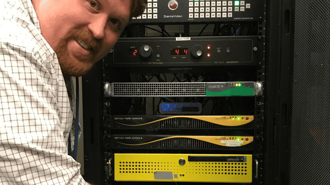 A man poses next to two Tightrope Media Systems Servers