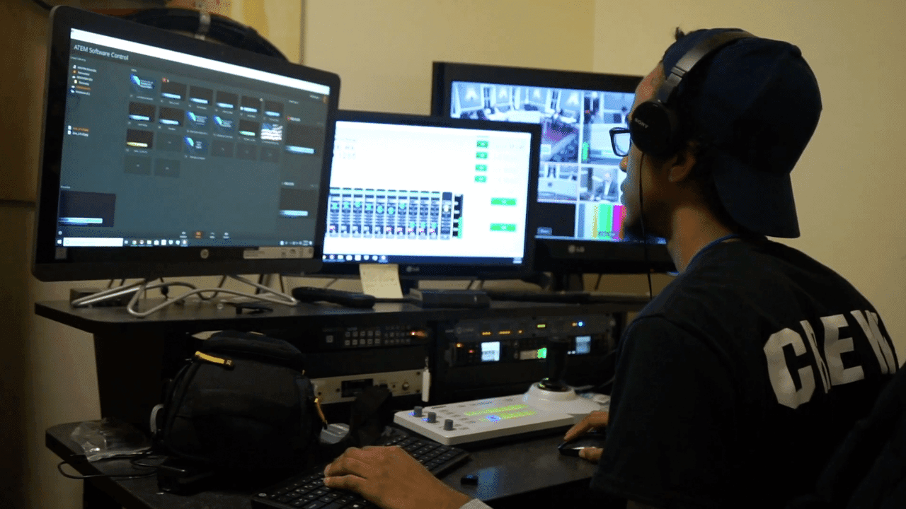 Picture of HCAM employee during production and editing of video for the channel