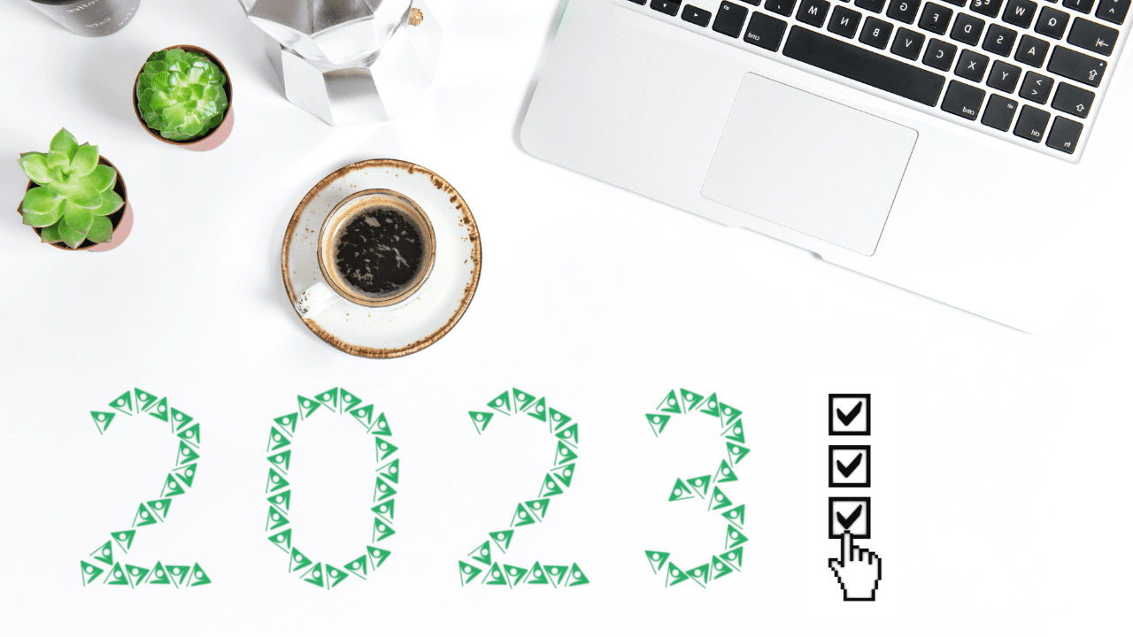 Top view of an office desk with a laptop, cup of coffee, plants, and a 2023 graphic using Cablecast by Tightrope Media Systems logo