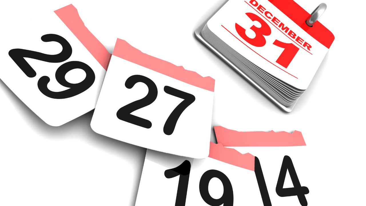 Several calendar pages with day numbers lay on a surface