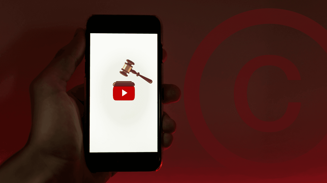 A hand holds a mobile phone with the YouTube app logo and a judge gavel over it, next to a copyright icon.