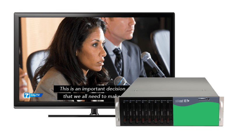 An image of a Cablecast VIO video playback server positioned in front of a monitor showing the server's program output on a TV screen with closed captions overlayed on a city council meeting.